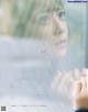 A woman looking out of a window with the words treat myself.